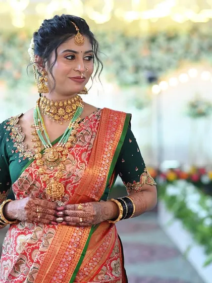 The bride looking radiant. Her custom blouse features a beautiful cut-out neckline that perfectly frames her traditional jewelry.
