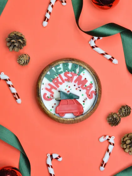 My "Merry Christmas" wooden bowl candle, featuring a cute red car carrying a Christmas tree. This candle is a cheerful and rustic addition to any holiday decor.