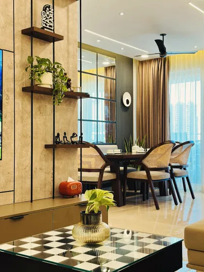 This image captures the view from the living room to the dining area, highlighting the open-concept design. The metal and wood shelving unit acts as a subtle divider while providing display space.