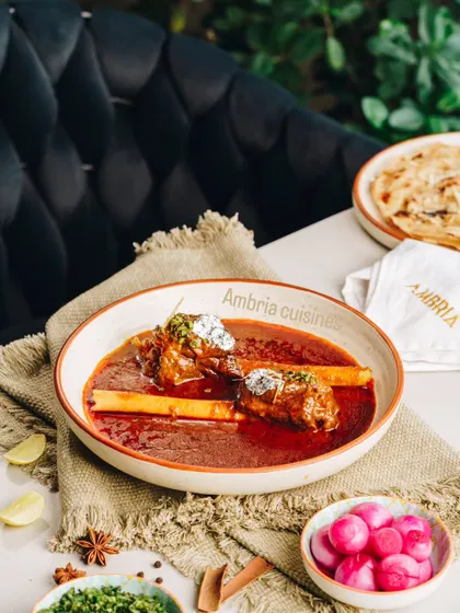 A bowl of our rich and aromatic Lamb Nalli Nihari. The meat is so tender it falls off the bone, served in a flavorful gravy best enjoyed with a fresh naan or roti.