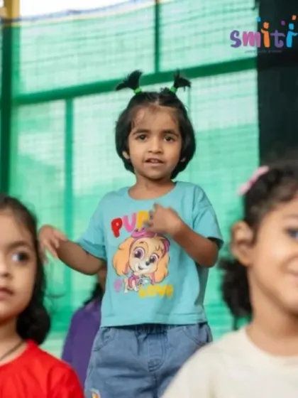 A girl sings with expression during the Grandparents' Day show. We encourage all forms of creative expression, from dance to music.