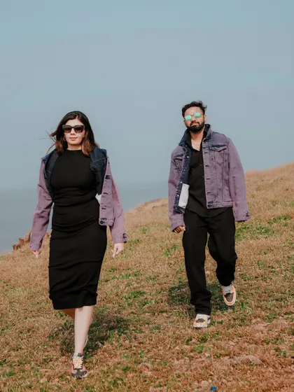 Capturing a cool, confident walk along a coastal hill. This shot has a candid, editorial feel, perfect for couples who want a stylish and modern pre-wedding album.