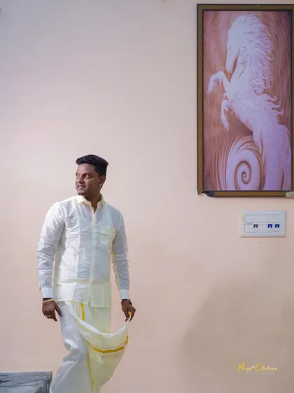 A handsome portrait of the groom in traditional South Indian attire. The simple background and natural light put the focus on his classic look.