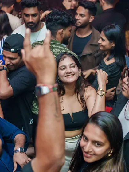 A classic rock-on sign from the crowd shows the universal language of a good party.