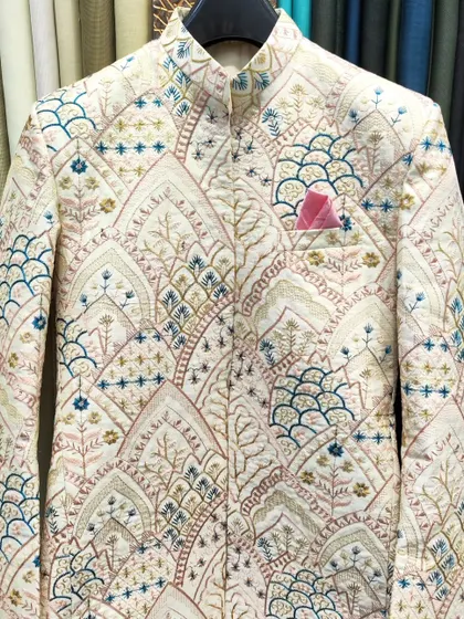 An open Jodhpuri jacket with beautiful, multi-colored architectural embroidery. This piece is available in four colors and can be customized to your measurements.