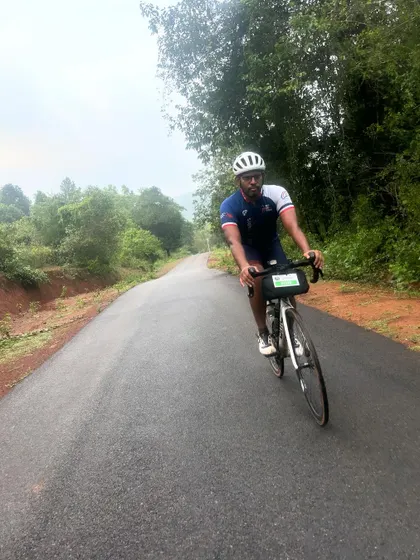 A rider pushes through a scenic, rolling country road during the Jog Falls 1000K BRM. The varied terrain keeps the ride challenging and engaging.