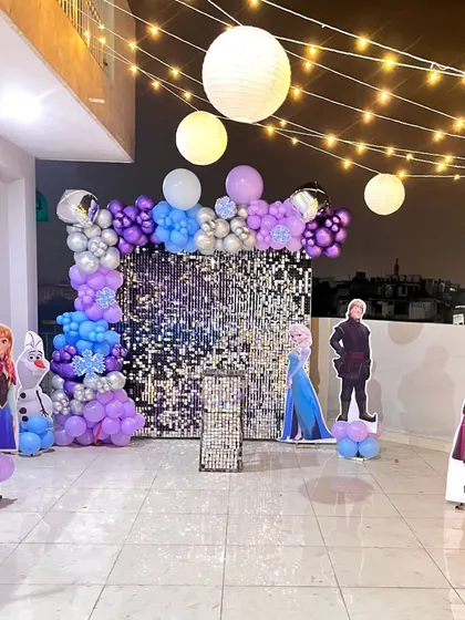 A wide view of the Frozen terrace party, where the sequin wall, balloons, and character cutouts create an immersive experience.