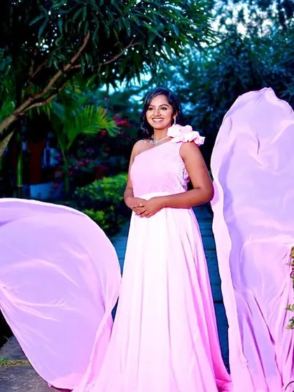 The long, flowing trails of this pink infinity gown create a sense of drama and movement in this beautiful garden shot.