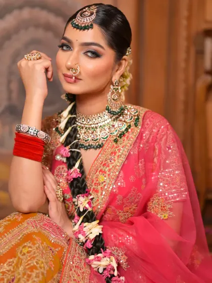 A seated portrait that captures the elegance of this bridal look. The makeup is soft yet defined, with a focus on creating a timeless and beautiful appearance.