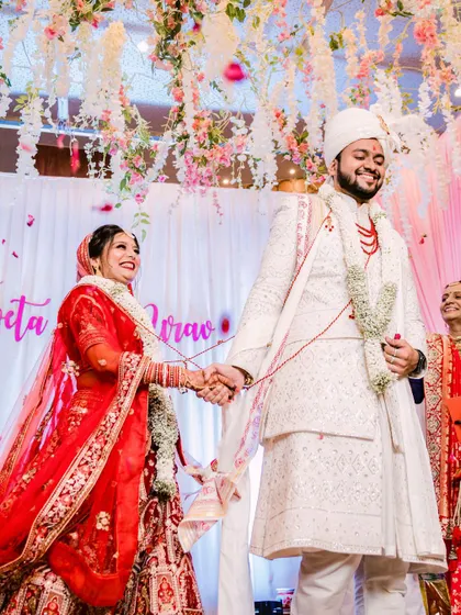 Hand in hand, Nirav and Shweta take their first steps as a married couple during their wedding ceremony. The smiles on their faces reflect the pure happiness of this milestone.