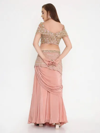 The back view of our peach draped outfit, showing the fully hand-worked details and the perfect custom fit. We ensure every angle is as stunning as the front.
