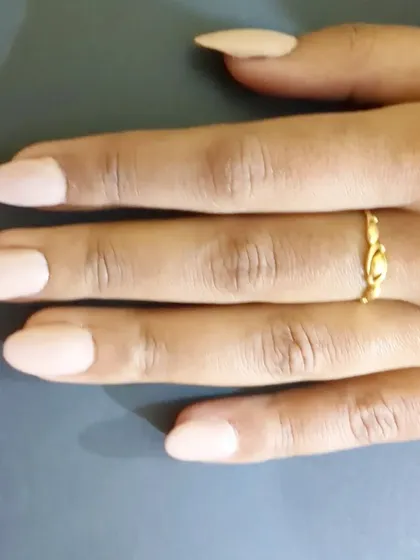 Another look at these perfect almond-shaped nails in a solid nude color. The shape elongates the fingers, and the high-gloss top coat gives them a durable, salon-quality shine.