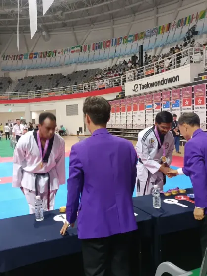 Bowing respectfully while receiving an award at the expo.