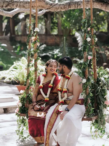 A classic portrait on the floral swing. This is a favorite spot for couples to capture a moment of shared joy, surrounded by the beauty of our ancient trees.