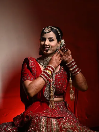 A candid moment of the bride getting ready. The intricate details of her jewelry and the flawless application of her makeup are highlighted in this shot.