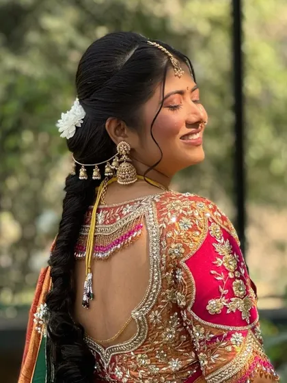 A Maharashtrian bride enjoying the golden hour at her destination wedding in Igatpuri. Her braided hairstyle is adorned with fresh flowers and traditional accessories.
