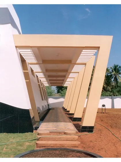 This image from a 2002 project showcases our long-standing use of dramatic architectural forms. The tapered columns of this pergola-d walkway create a powerful visual rhythm, a design principle we continue to explore in our contemporary work.