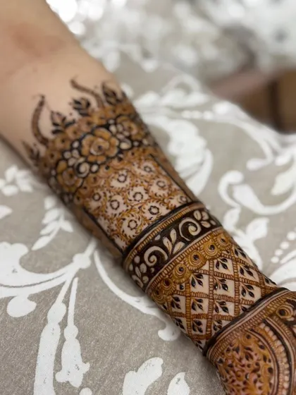 A detailed shot of the floral cuff design on the forearm.