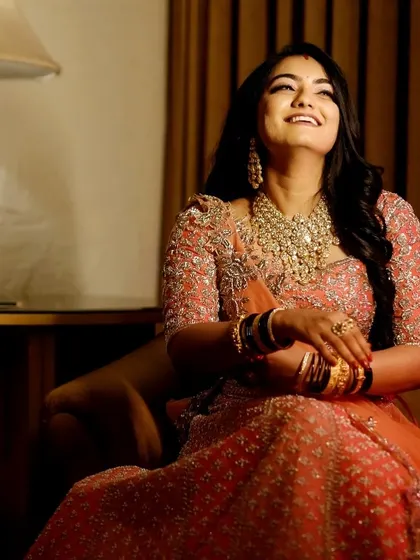 This candid shot captures a moment of pure joy. The makeup is glamorous and radiant, designed to make the bride feel like a star on her special day.