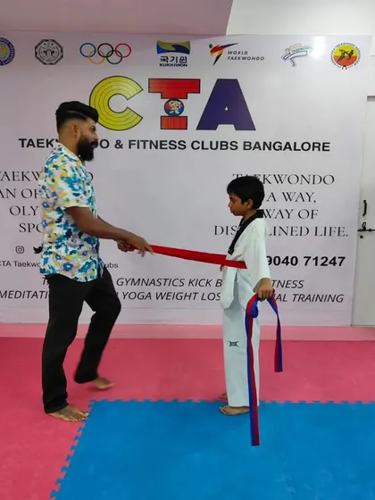 Tying a red belt.