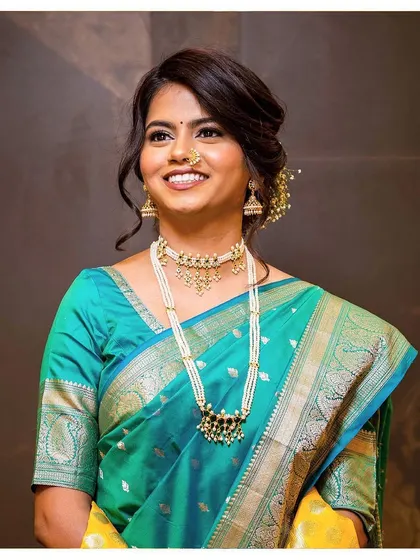 Ashlesha's wide smile says it all. Her wedding look was classic and elegant, with gold glitter eyes and a flawless base that looked beautiful both in person and on camera.