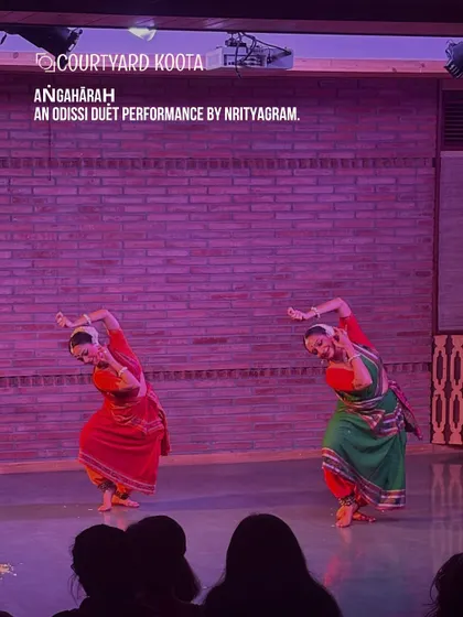 The grace of Odissi fills our stage. Here, dancers from the renowned Nrityagram perform 'Aṅgahāraḥ', a duet that showcases perfect synchronization and emotive storytelling, bringing ancient traditions to a contemporary audience in a close-up, personal setting.