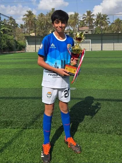 A member of the U14 Feugo Tigers team with his winner's trophy.