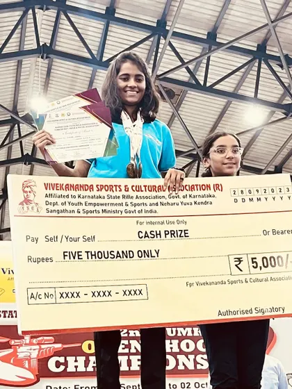 A student celebrating her win at the Tumkur competition. These victories are a result of the collective effort of the shooter, coaches, and their supportive families.