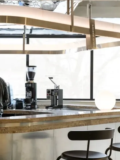 The reflective overhead light fixture mirrors the activity at the brew bar, adding another layer of visual interest.