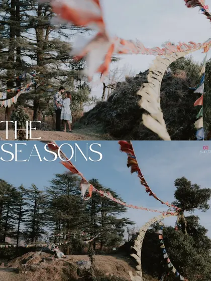 A creative shot using Tibetan prayer flags to frame the couple against the mountain landscape, symbolizing blessings for their journey.