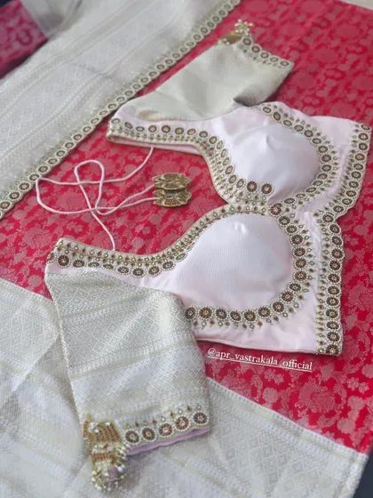 The full layout of the off-white blouse with matching tassels.