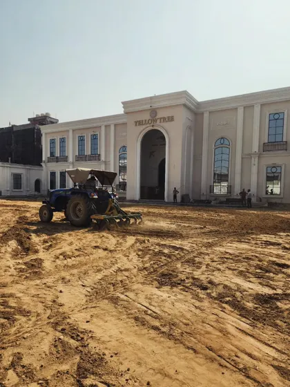 Large-scale landscaping requires heavy equipment. Here, a tractor is leveling the ground at Yellow Tree Banquets to create a perfectly flat base for the expansive lawns.