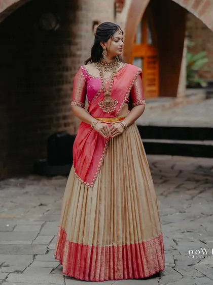 A full-length shot of the bride, her pose elegant and her attire a perfect mix of tradition and modern flair.