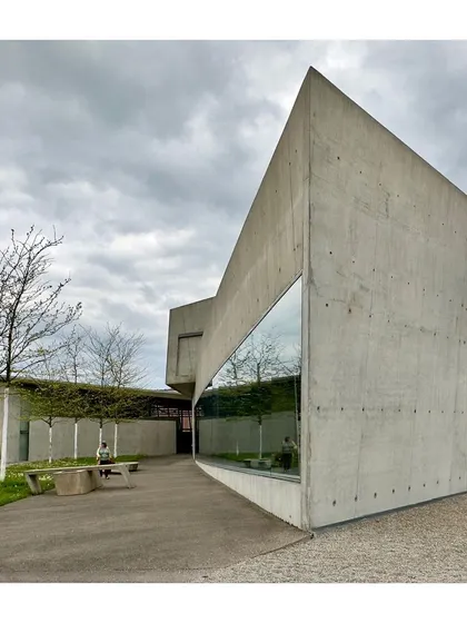 The sharp, angular forms of Zaha Hadid's building create a powerful silhouette against the sky.