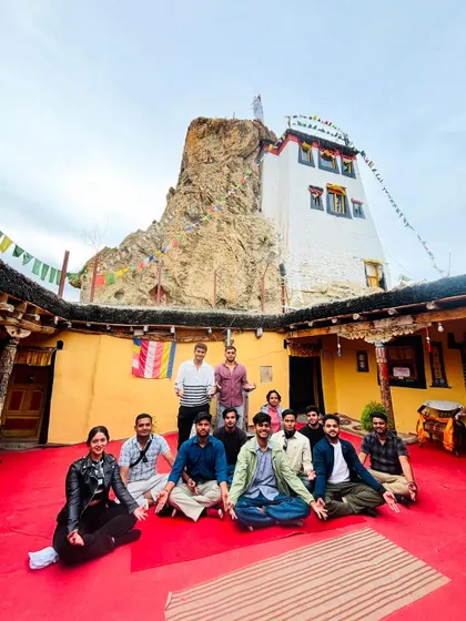 The group sitting together inside the courtyard of a Spiti monastery. These moments of quiet reflection and cultural immersion are what make the trip so special.