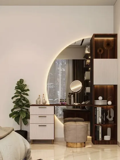 This dressing area features a large, round backlit mirror that creates a glamorous focal point. The compact drawers and open shelving provide practical storage.