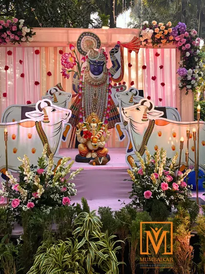 A full view of the Krishna-themed wedding stage. The decor combines traditional motifs with fresh flowers and elegant draping, creating a sacred and beautiful space for a wedding ceremony.