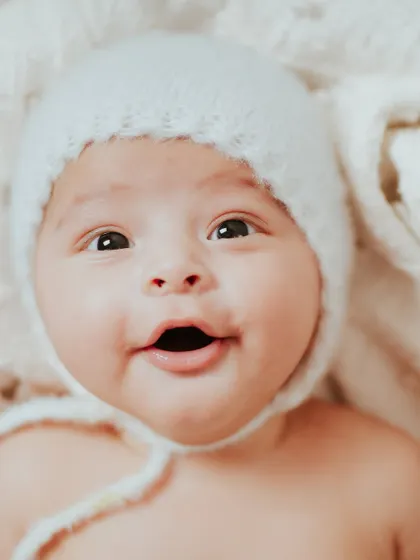 A bright-eyed and happy baby. His personality is already shining through at just a few months old.