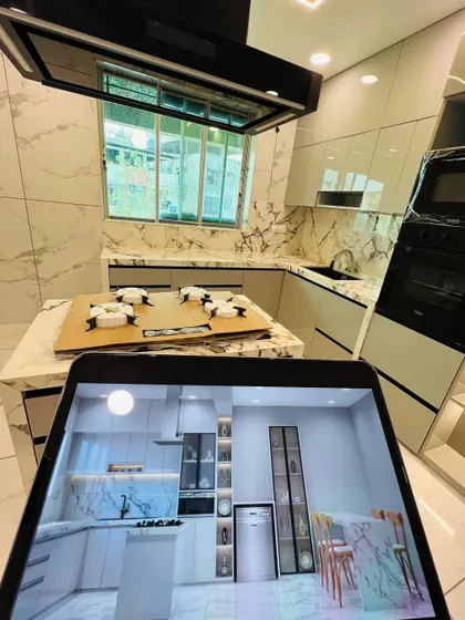 Another angle comparing the digital plan to the physical space. We ensure every element, including the placement of the chimney hood, oven tower, and island, is precisely executed according to the approved design.