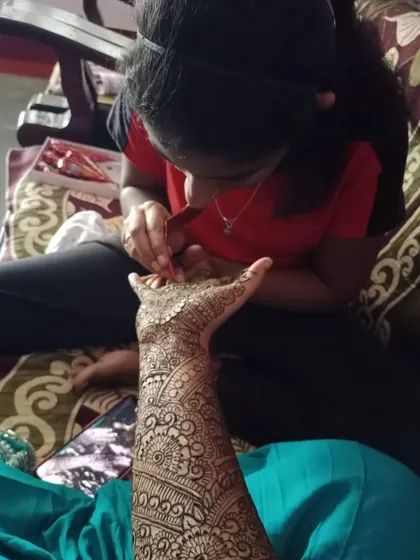 A photo of me applying a detailed bridal mehendi. I focus on every line to ensure the final design is perfect for my client's special day.