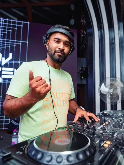 A quick thumbs-up from the console. I always make sure to connect with the crowd and let them know we're all in this together for a great night.