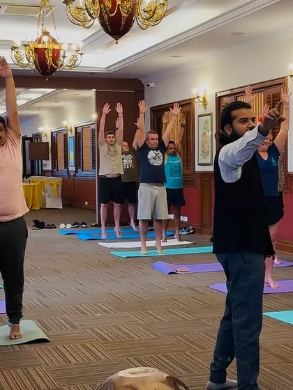 Guiding office employees through simple standing yoga poses they can do anywhere.