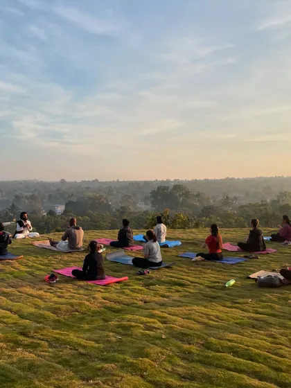 The session concludes with a seated meditation, allowing participants to absorb the benefits of the physical practice. The serene landscape provides a perfect backdrop for finding inner stillness.