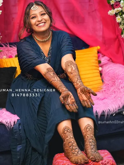The joy on a bride's face is everything. This is why I pour my heart into every design. Here you can see a complete bridal look, with detailed henna on both the hands and feet, telling her unique wedding story with peacocks and doli motifs.