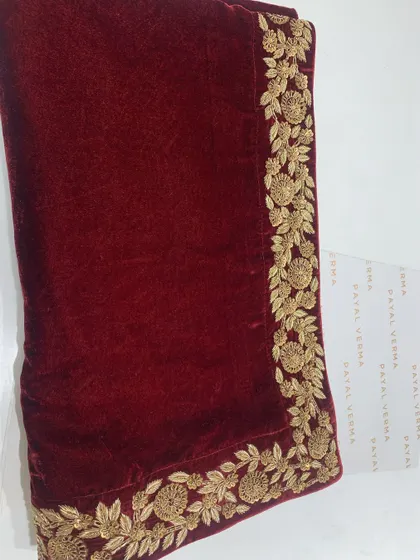 The rich texture of oxblood velvet paired with golden dabka embroidery. This is a detail shot of a custom odhni, perfect for the wedding season.