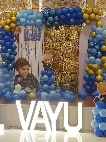 Another look at a fantastic Boss Baby theme for Vayu's first birthday. The combination of blue and gold balloons with a sequin backdrop creates a rich and festive look.