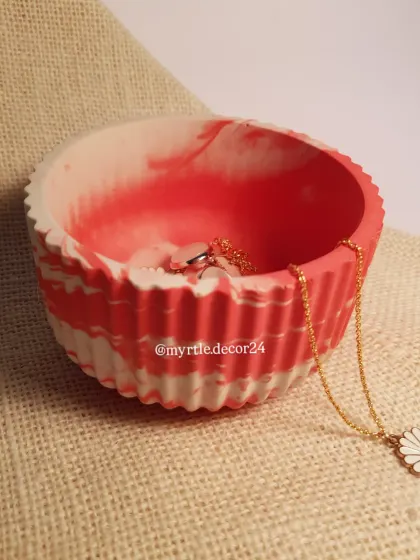 A side view of our custom red and white marble round jar, highlighting the beautiful swirls of color.