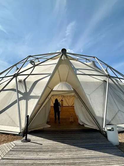 The Geodesic Dome at the Vitra Campus, designed by Buckminster Fuller. This structure is a landmark of engineering and efficiency, creating a vast, column free space for congregation.