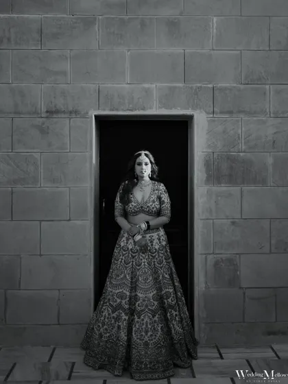 The same powerful bridal portrait of Urjaa, rendered in classic black and white. This version emphasizes the form, texture, and timeless elegance of the moment.