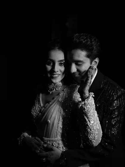A dramatic black and white shot that captures an intimate moment between the couple. The focus is on their connection and the bride's beautiful, radiant makeup.